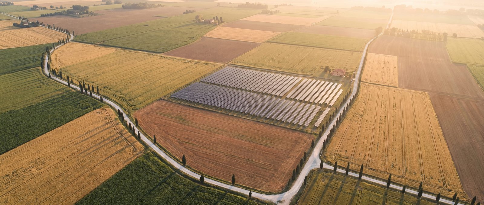 Aerial patchwork of northern Italian farmland with an integrated solar block